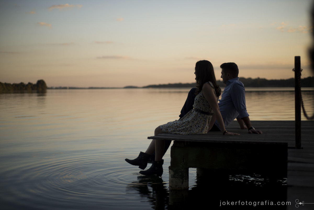 casal aproveitando o por do sol no lago