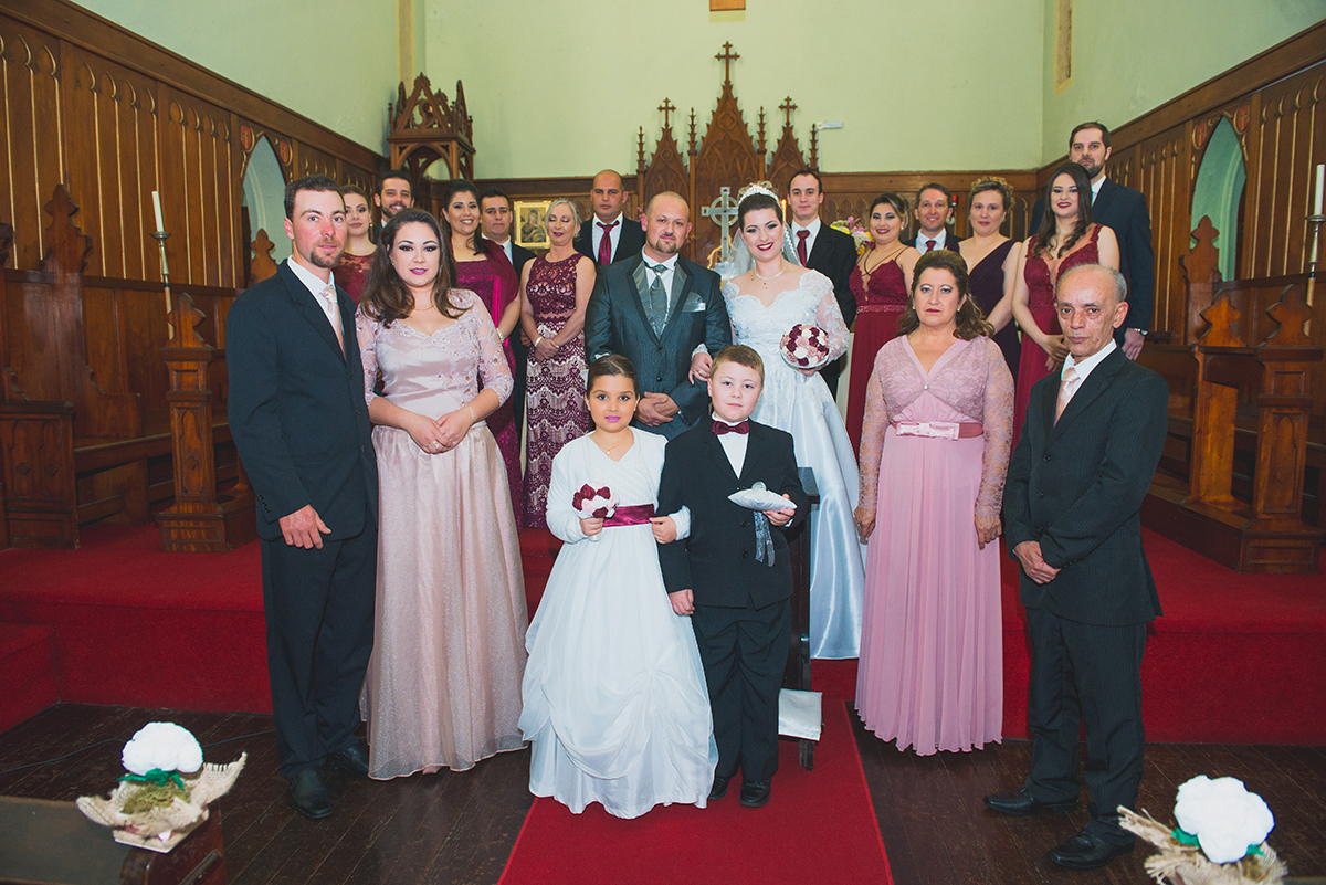Foto oficial dos noivos, padrinhos e familiares no altar após o casamento. Foto por Marco Moscarelli.