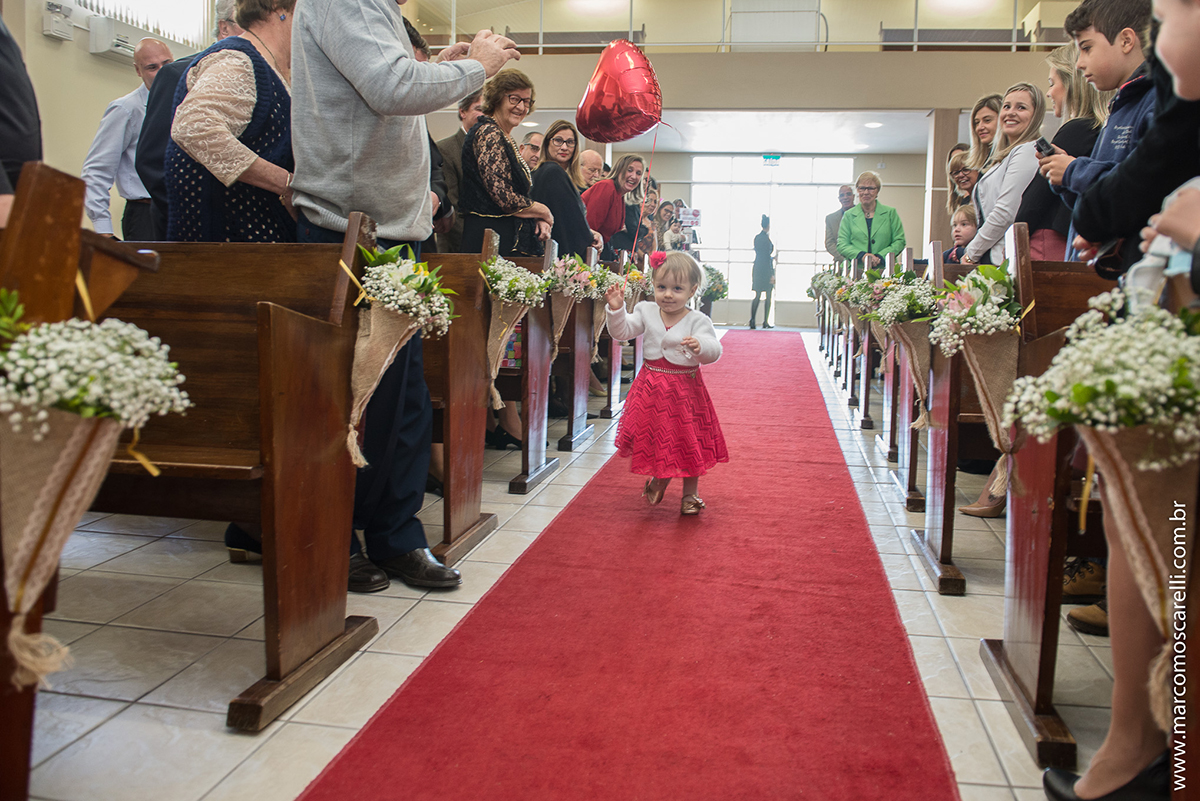 Entrada da daminha ou aia na cerimonia de casamento carregando um lindo blão vermelho em forma de coração. Foto por Marco Moscarelli