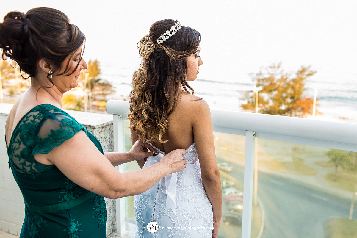 mãe da noiva prendendo vestido