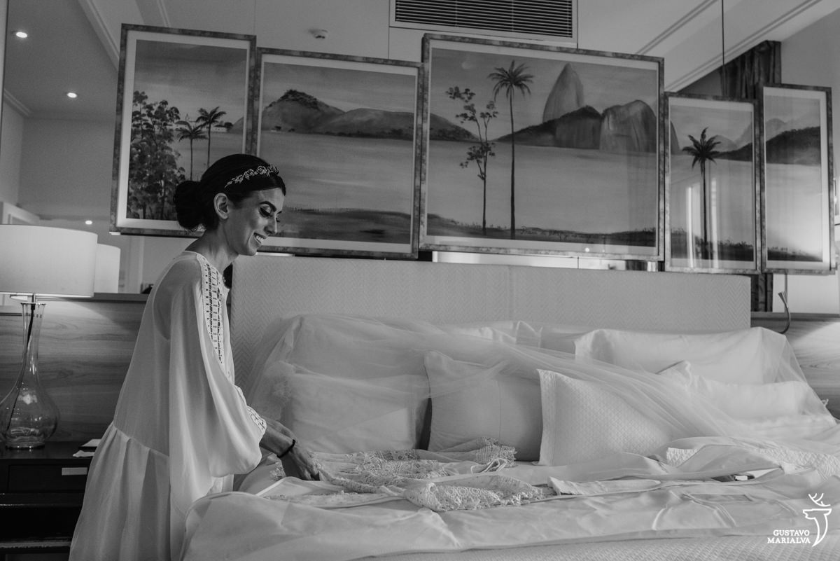 noiva arrumando o vestido na cama do hotel copacabana palace