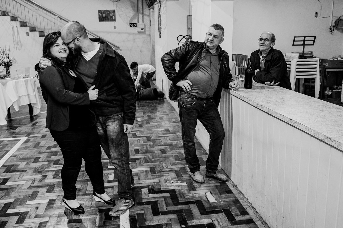 Dad observing his daughter while she is kissing her husband black and white picture