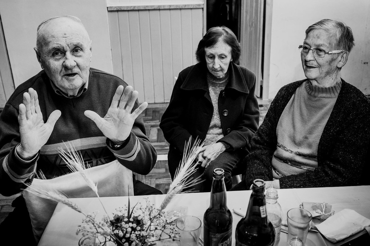 old people with expressive faces sitting together