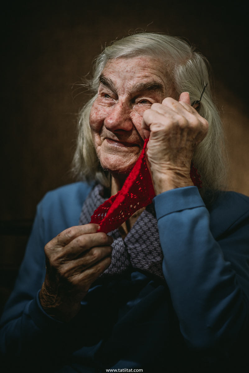 elderly woman honors her deceased brother with a handmade napkin made by him