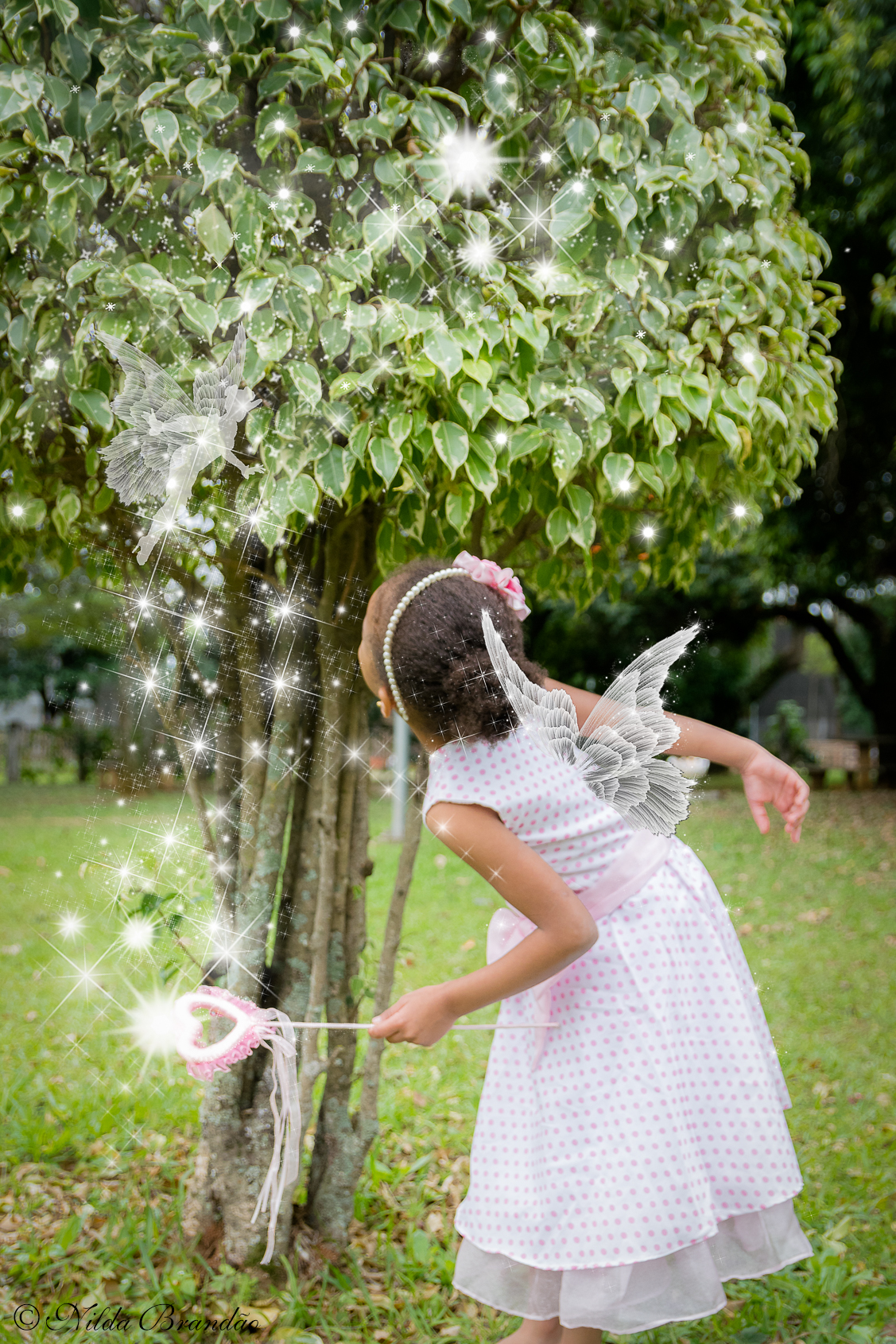 Ensaio infantil de fantasia, Julia faz aparecer uma fadinha com sua varinha magica.
