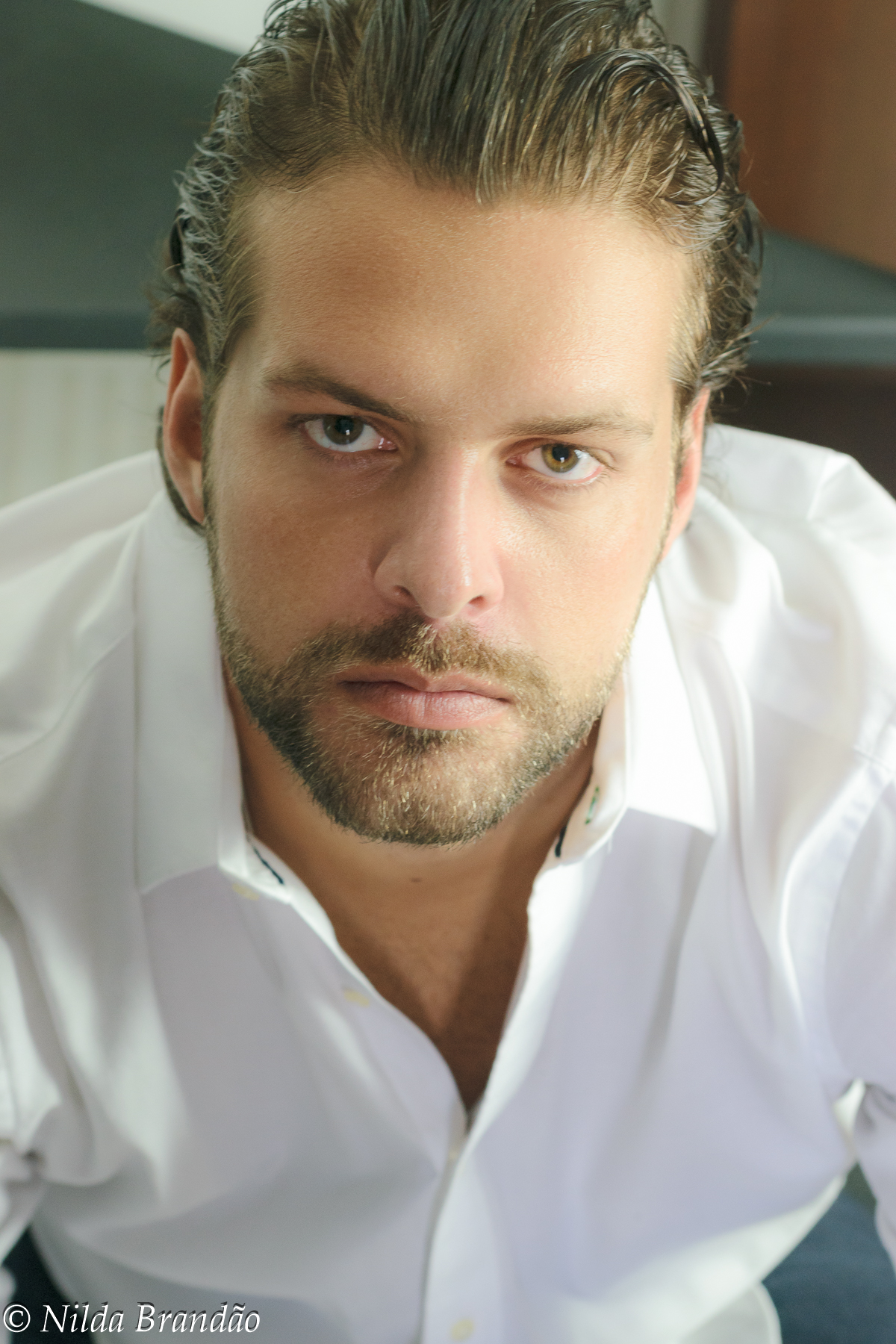Retrato de ensaio masculino, usando camisa branca, a barba e o cabelo molhado dão o charme nessa imagem.