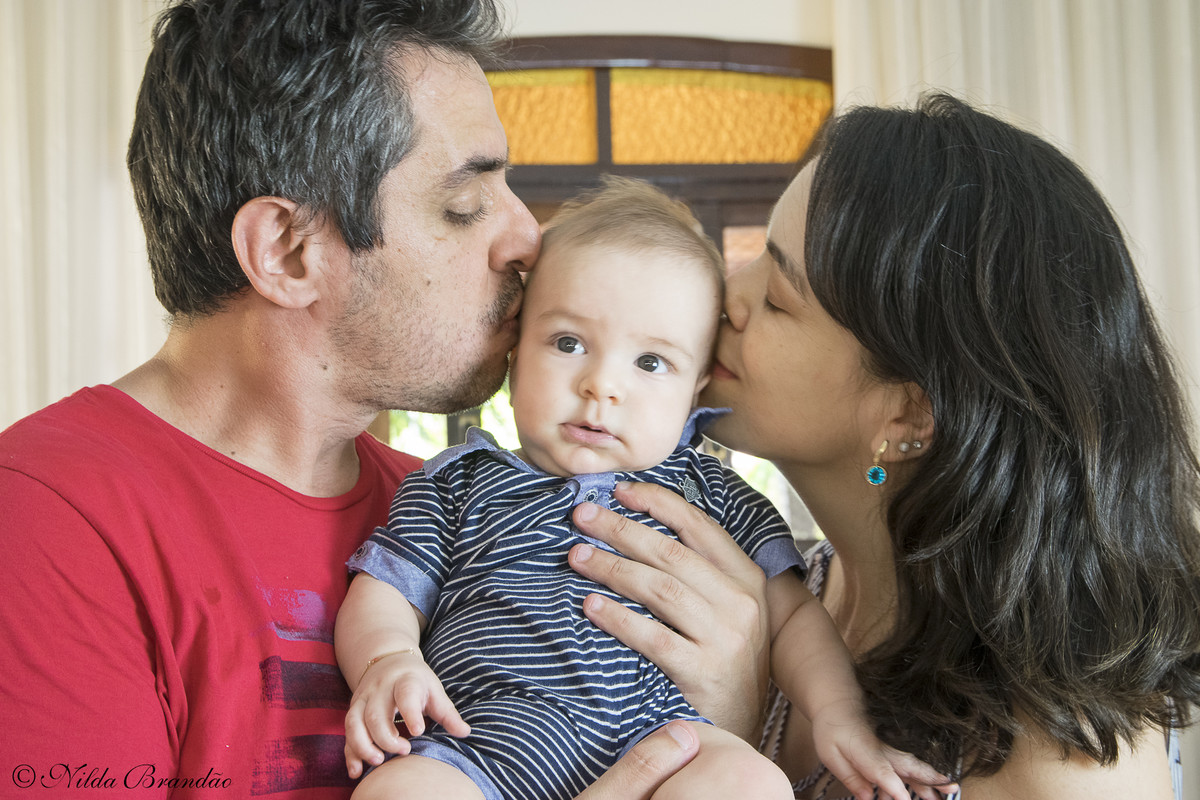 Papai e mamãe beijando o bebê, esse tipo de fotografia nunca sai de moda.
