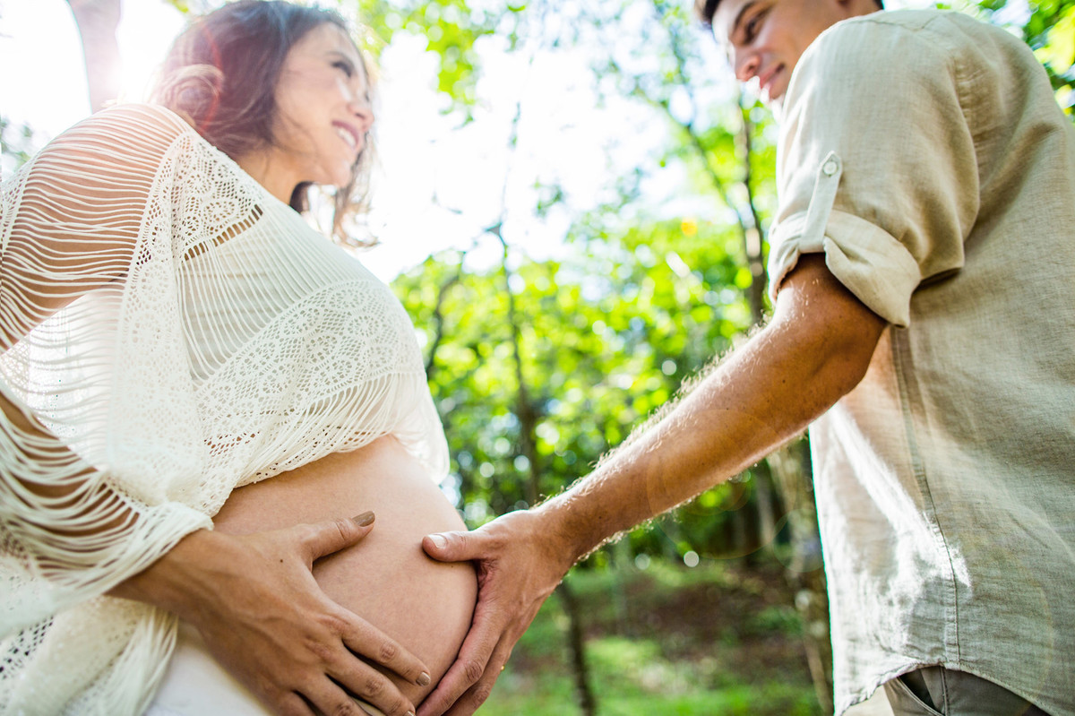 Marido passando a mão na barriga da esposa grávida. Foto feita pelo fotografo de gestante Rafael Ohana em Brasilia-DF