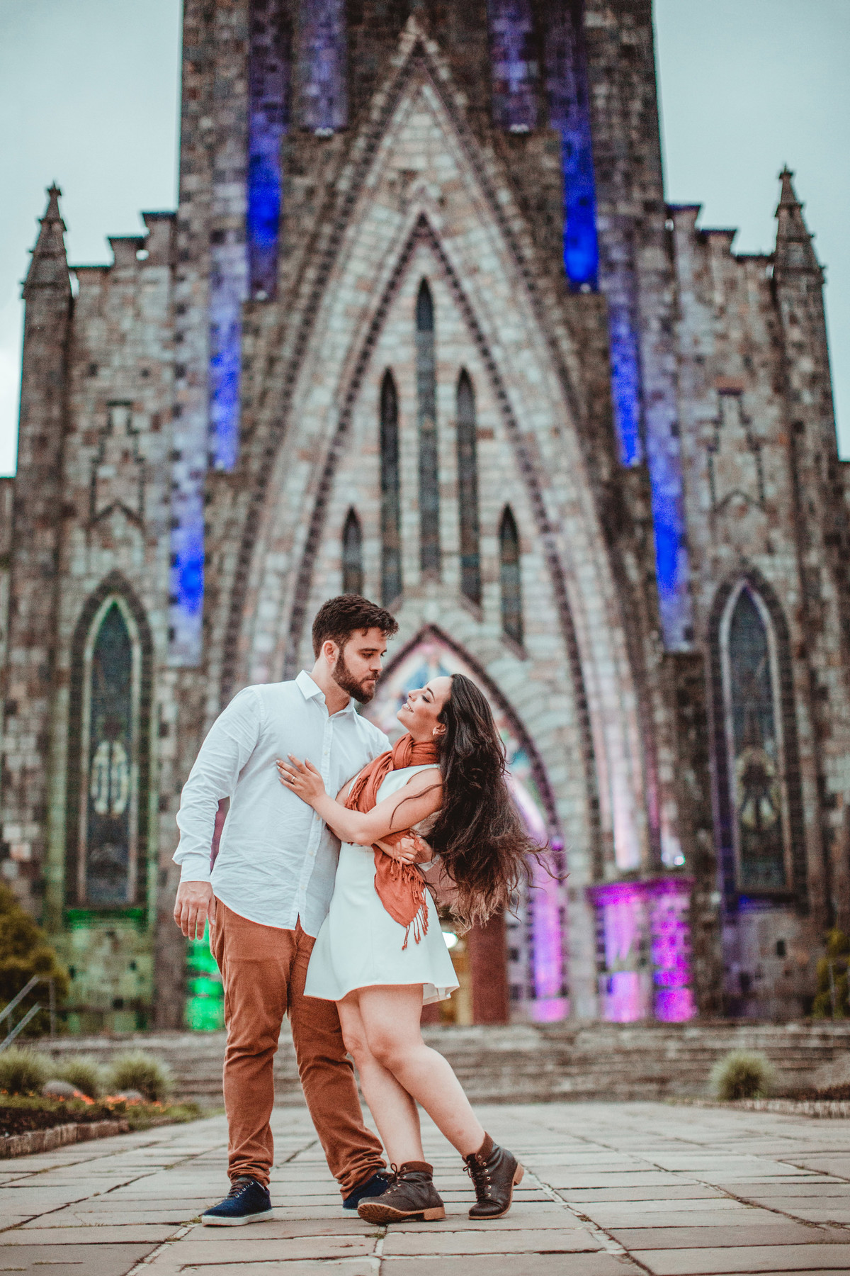 Casal se divertindo em ensaio romântico em frente a Igreja Matriz de Canela-RS. Foto feita pelo fotógrafo de casamento Rafael Ohana