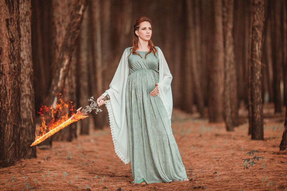 Grávida com espada flamejante na floresta. Foto feita pelo fotógrafo de grávidas Rafael Ohana em Brasilia-DF