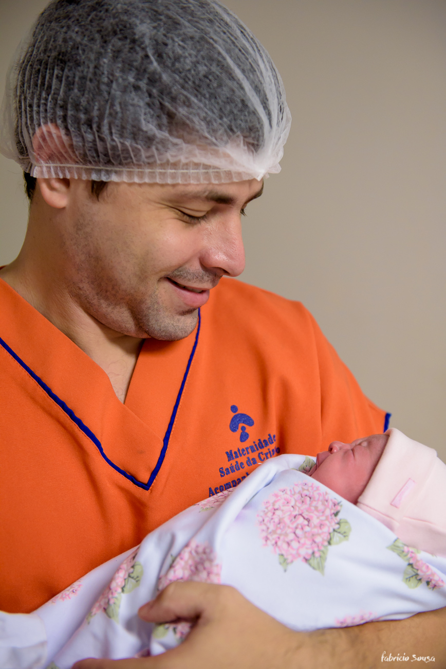 papai segura orgulhoso sua filha no colo