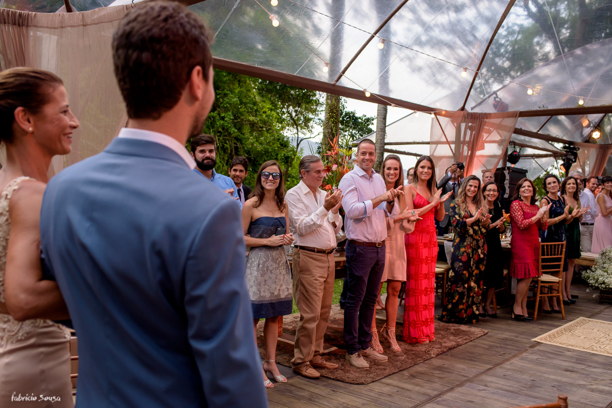 convidados aplaudem noivo e sua mãe na entrada do cortejo do casamento