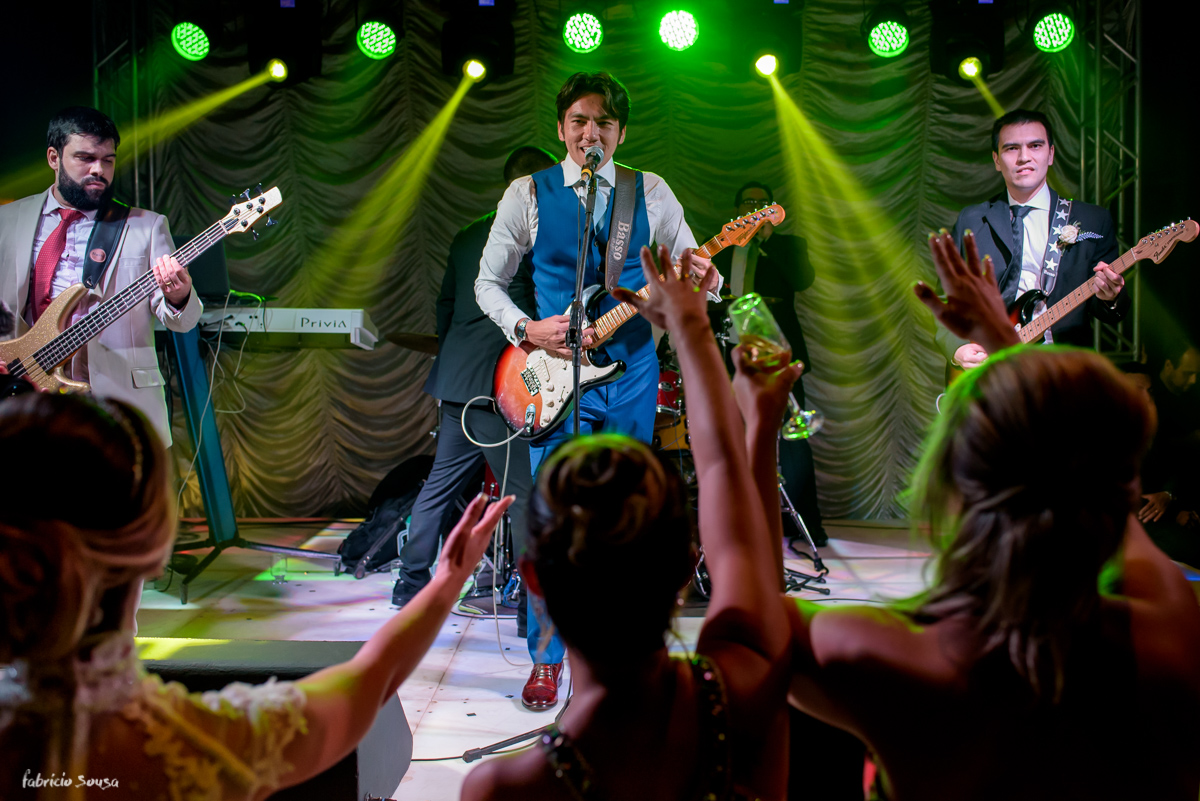 noivo toca guitarra e noiva dança na festa de casamento