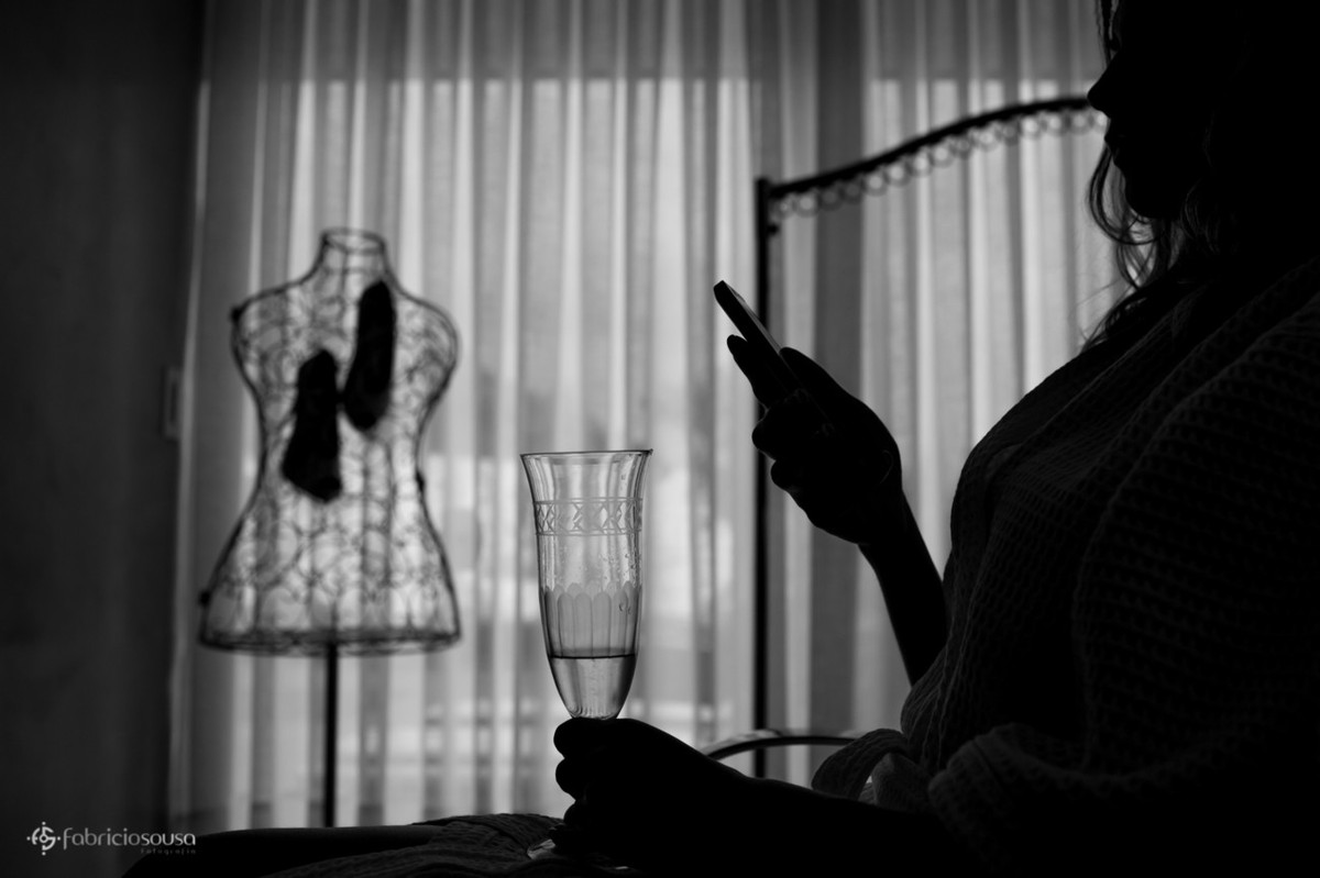 noiva no celular e tomando espumante no making of