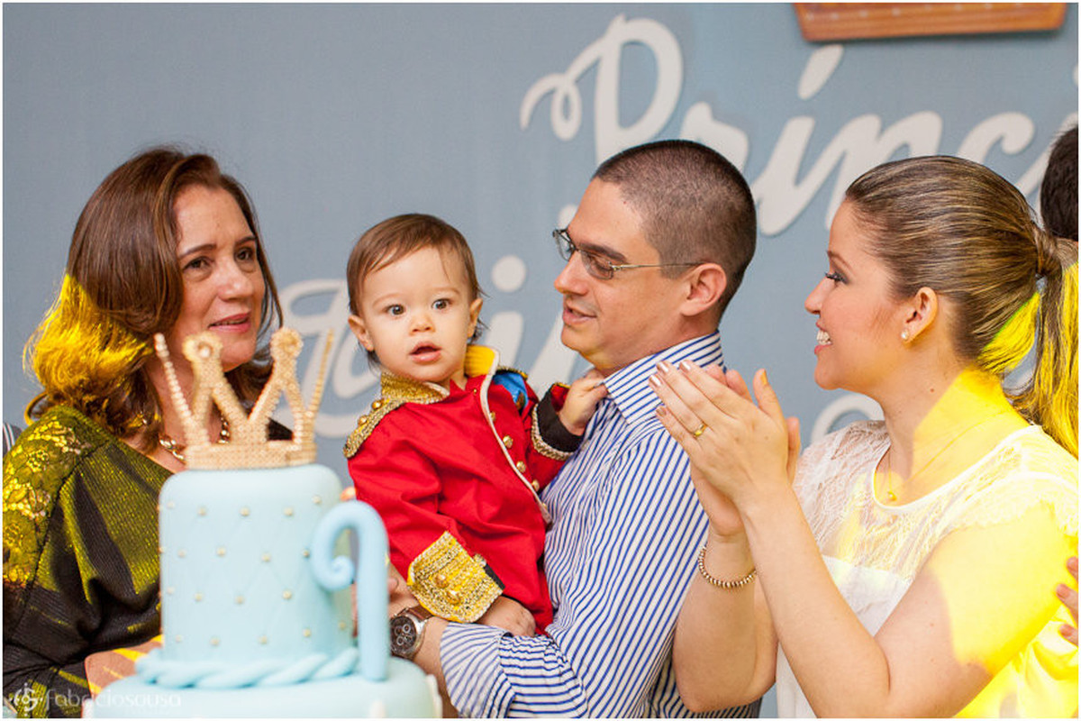 Família com o aniversariante em torno do bolo