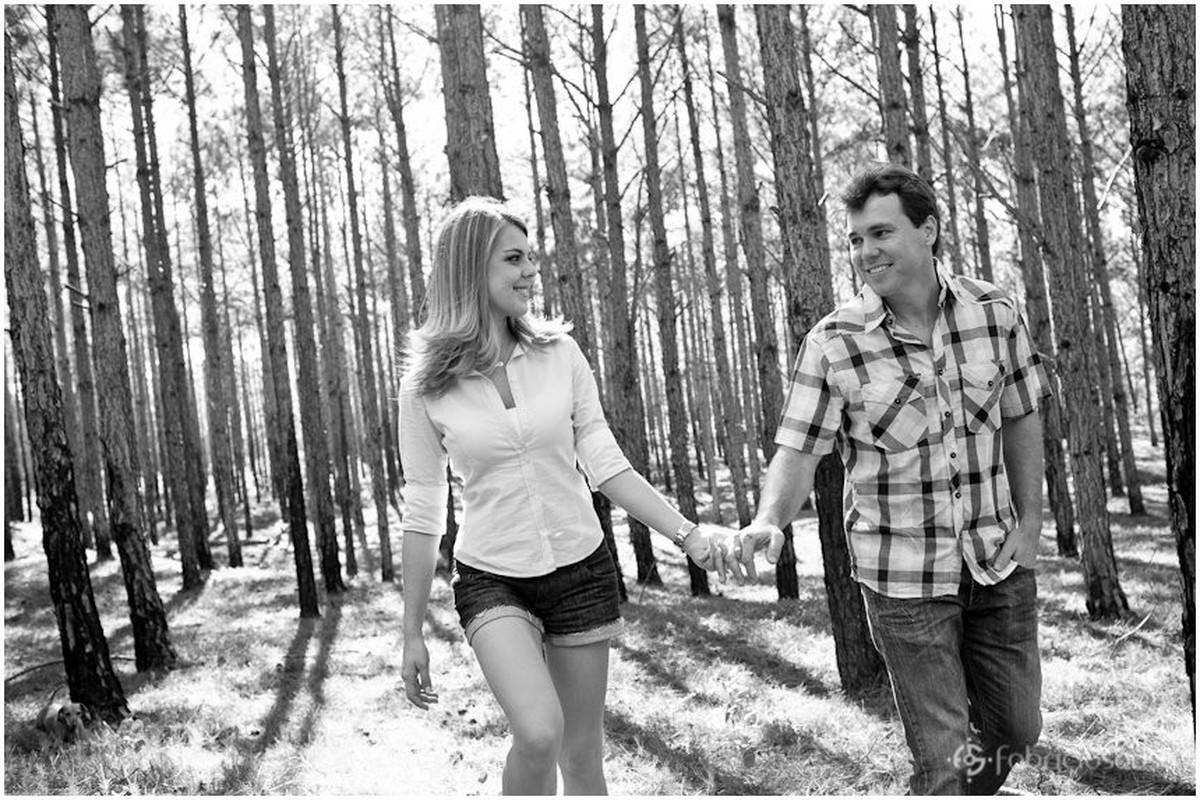 casal caminhando de mãos dadas no bosque