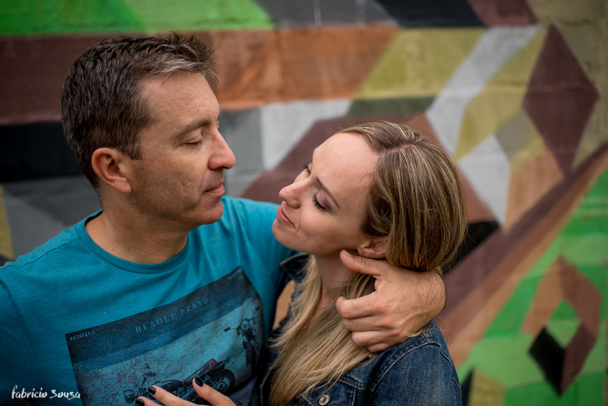 troca se olhares com muro grafitado colorido ao fundo