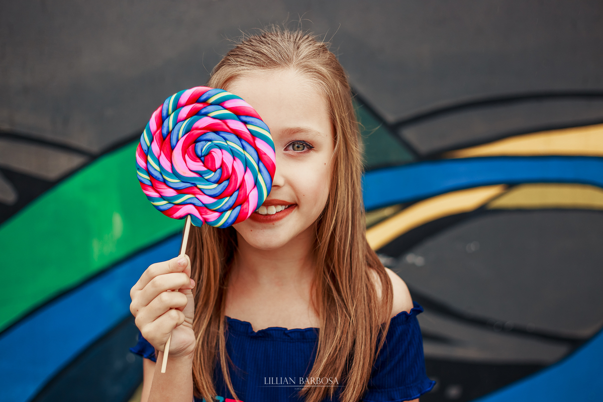 ensaio fotografico de 9 anos de menina - julia fez nove anos com book em lauro muller fotografa lillian barbosa fotos com pirulito em muro colorido