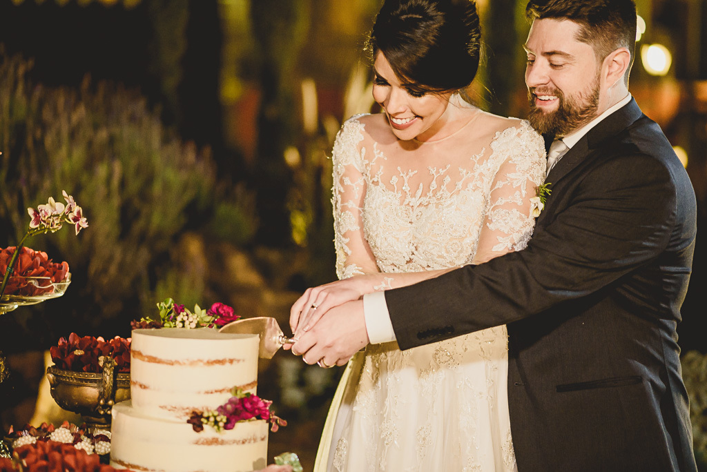 Casal na mesa do bolo em festa de casamento no Villa Giardini fotógrafo profissional Brasília Df