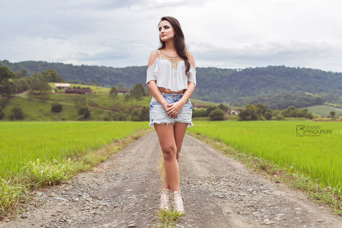 Modelo Aline em estrada de interior em meio a plantação de arroz. Fotografia de Eduardo Pasqualini, fotógrafo de casamentos e ensaios em Rio do Sul, Santa Catarina.