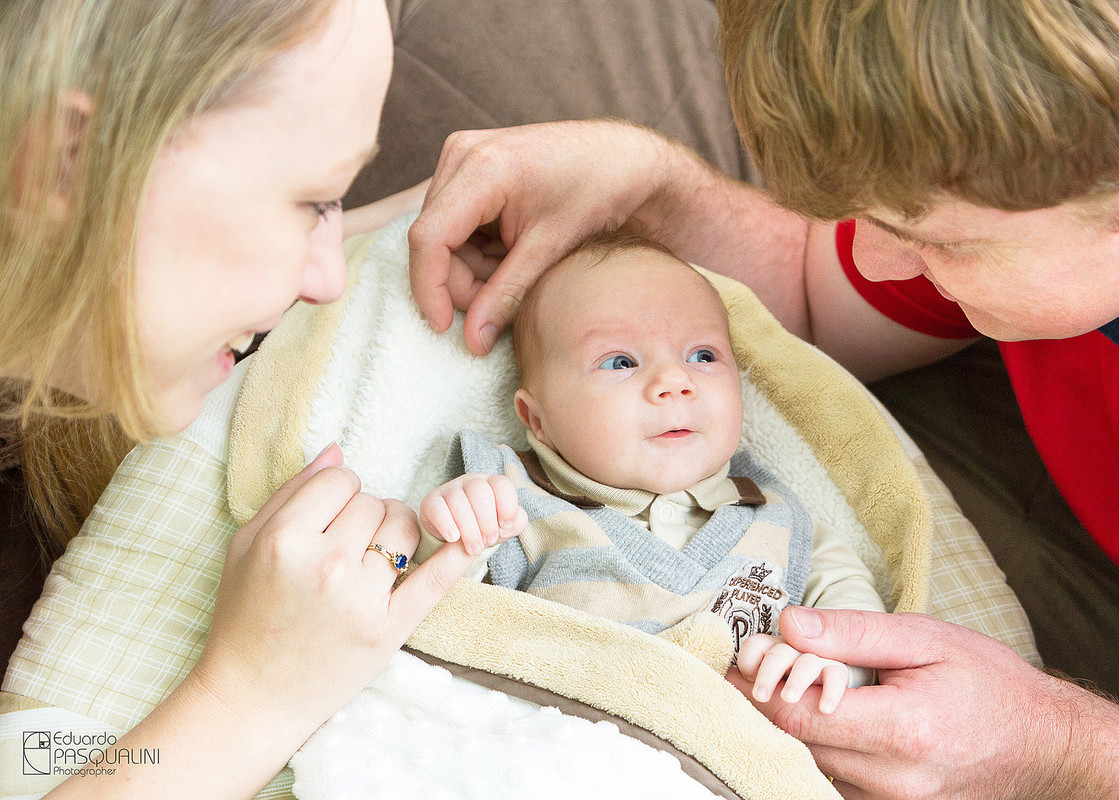 Pai e mãe brincando com bebe. Fotografia de Eduardo Pasqualini, fotógrafo de casamentos e ensaios em Rio do Sul, Santa Catarina.