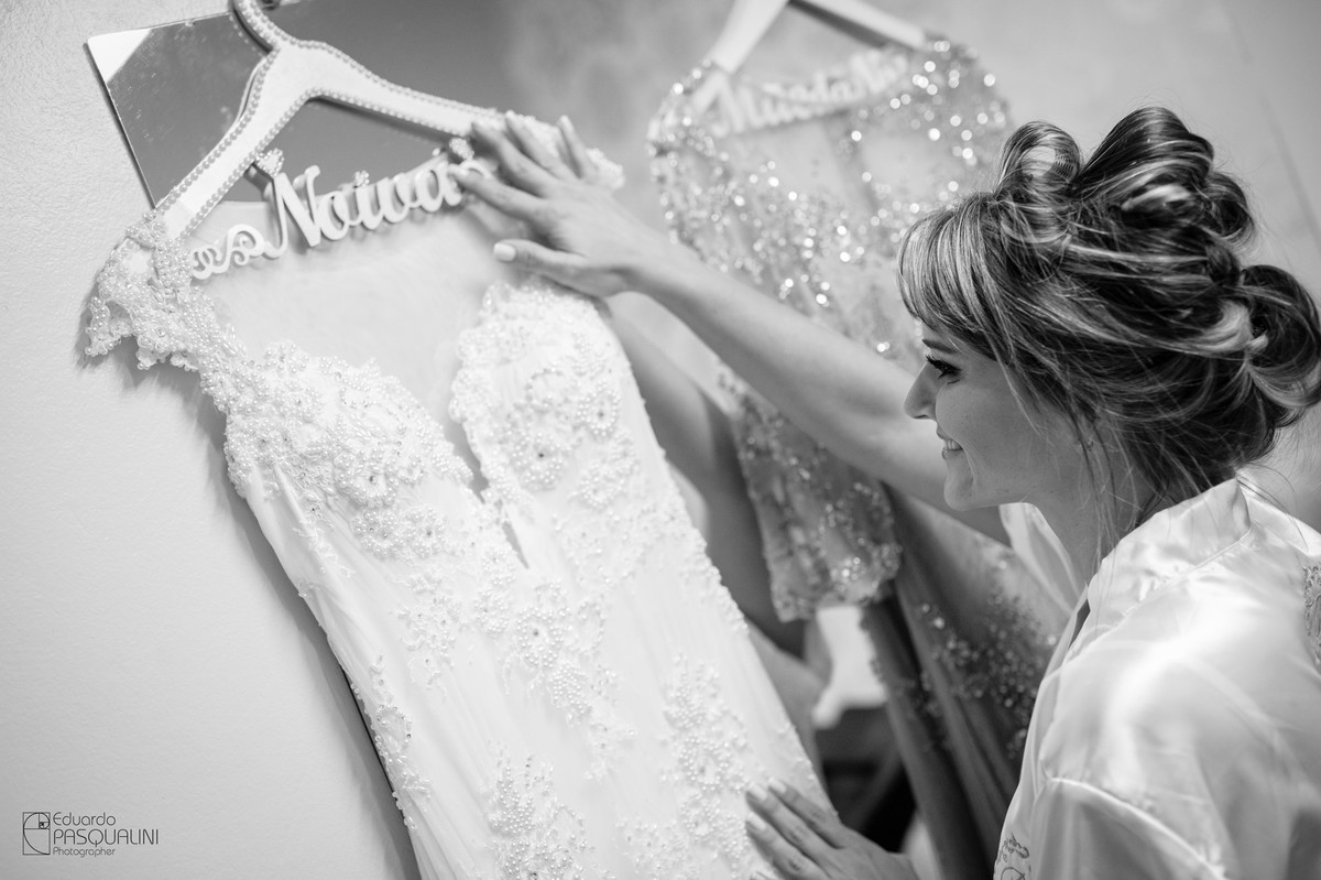 Noiva acariciando seu vestido. Fotografia de Eduardo Pasqualini, fotógrafo de casamentos e ensaios em Rio do Sul, Santa Catarina.