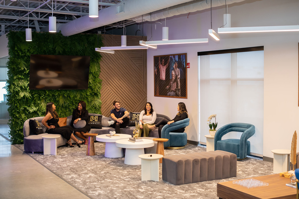 Dynamic office lounge in Orlando, FL featuring a vibrant mix of casual and formal seating areas, perfect for interior and real estate photography. Ideal for highlighting in property portfolios.