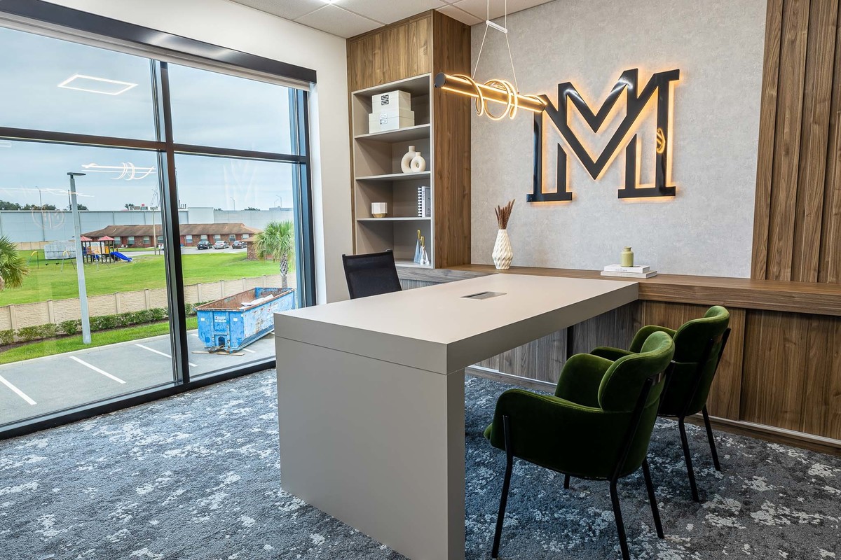 Modern executive office in Orlando, FL featuring a sleek desk setup with panoramic views, optimized for interior and real estate photography. Highlights contemporary design and functional elegance.