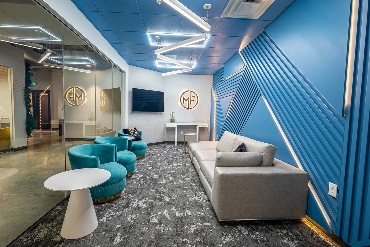 Modern office space in Orlando, FL ideal for interior and real estate photography. Features vibrant blue walls, stylish seating, and distinctive lighting, creating a visually appealing environment perfect for showcasing