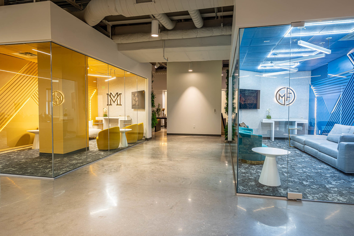 Sophisticated office space in Orlando, FL featuring a mix of vibrant and neutral tones, perfect for interior and real estate photography. Features reflective glass walls and dynamic lighting, ideal for property portfolios.