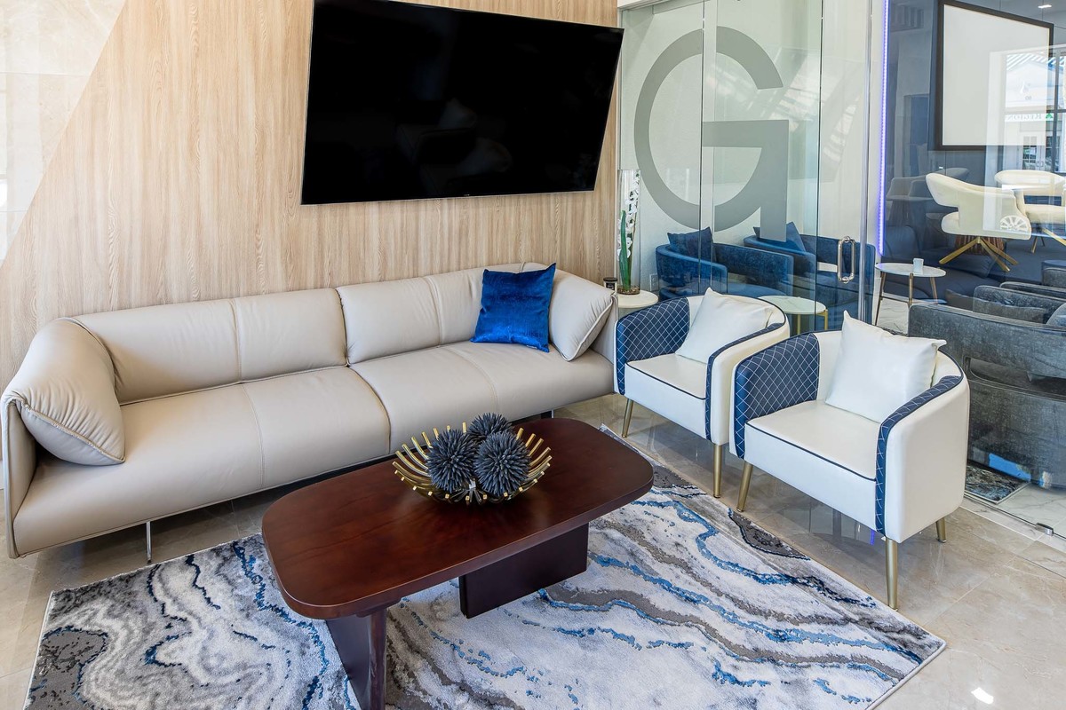 Cozy lounge area with a minimalist sofa, designer chairs, and elegant décor, blending comfort and style seamlessly for a modern business space.