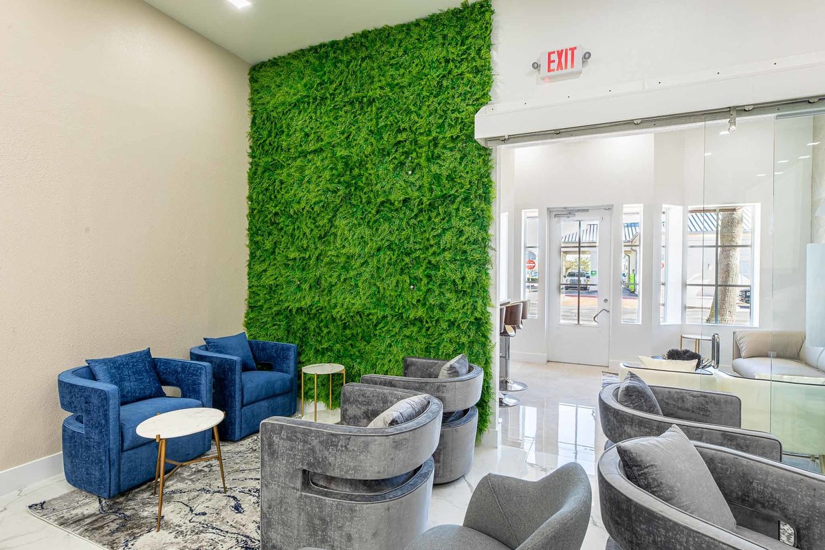 Cozy lounge area with a minimalist sofa, designer chairs, and elegant décor, blending comfort and style seamlessly for a modern business space.