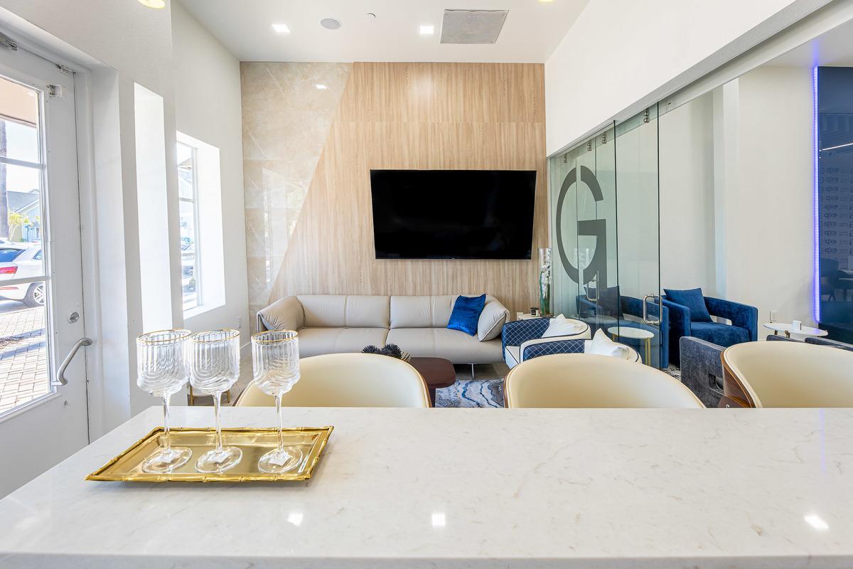 Bright seating area with contemporary furniture, large windows, and natural light creating an inviting and stylish ambiance.