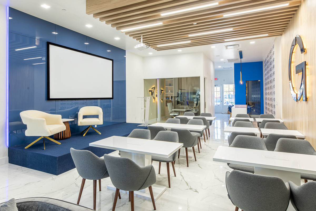 Spacious conference room with modern chairs, wood accents, and high-quality lighting, perfect for professional meetings and events