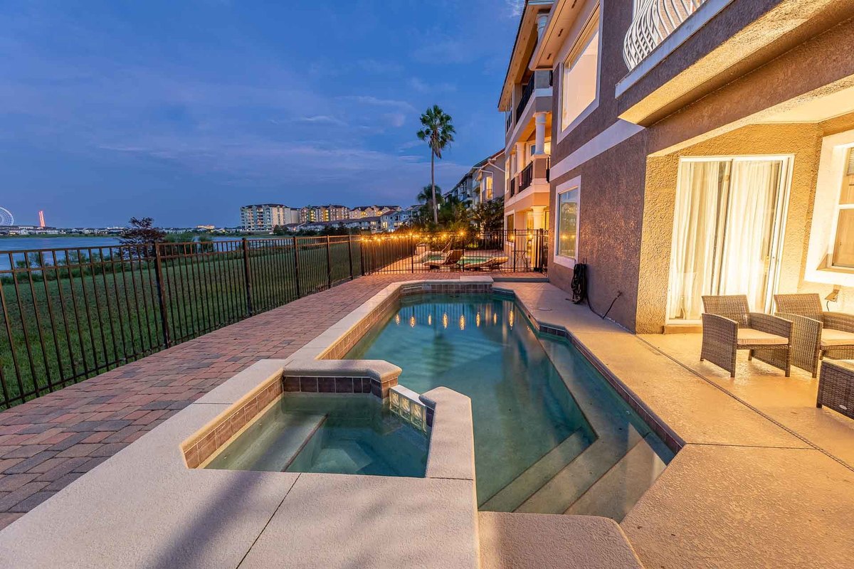 Twilight view of a luxurious pool by a lakeside home in Orlando, beautifully captured by a local photographer.