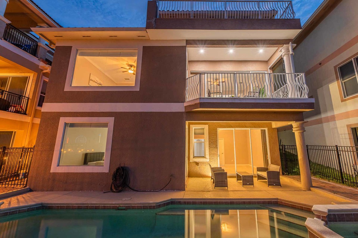 Orlando home's exterior at dusk, featuring poolside lighting and architectural details, highlighted by a professional photographer.