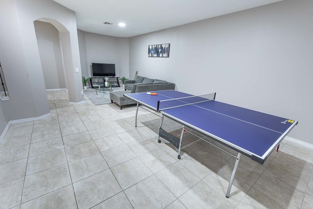 Spacious game room with a ping-pong table, captured by a photographer in an Orlando home's interior.