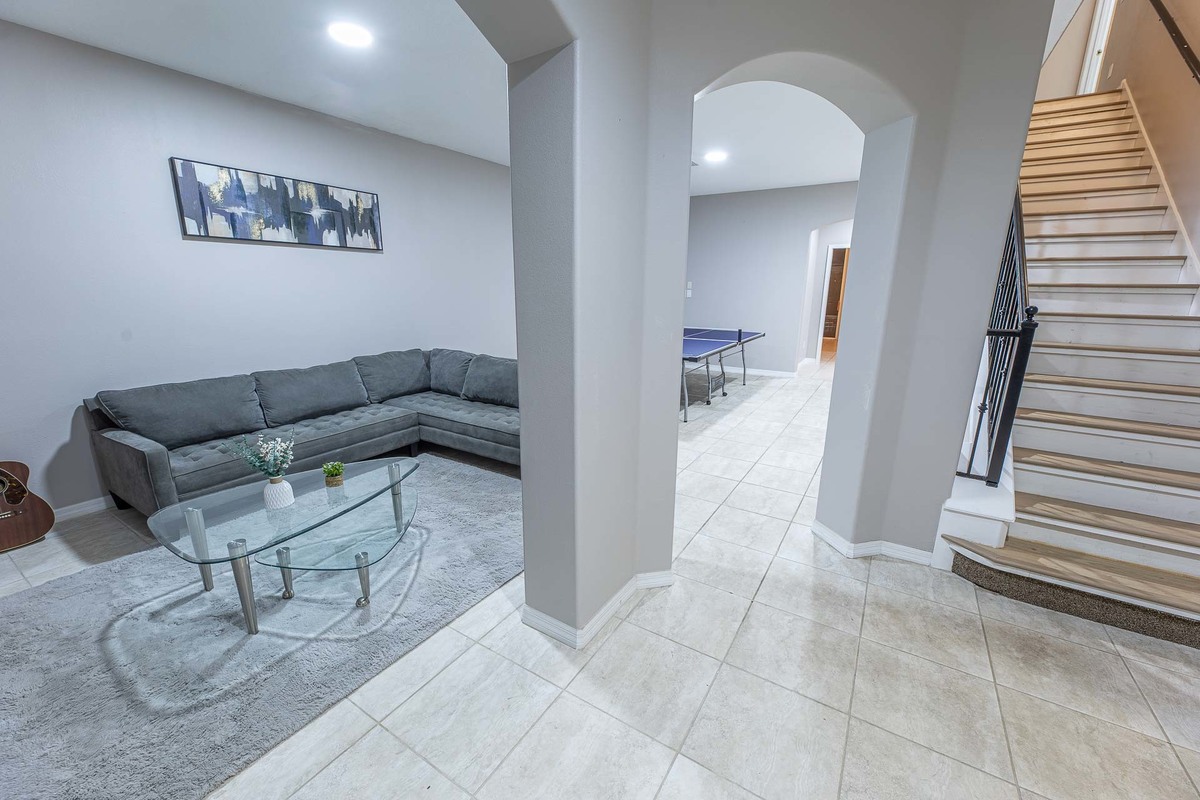 Recreational space in an Orlando home featuring a ping-pong table, neatly captured in the expansive interior.