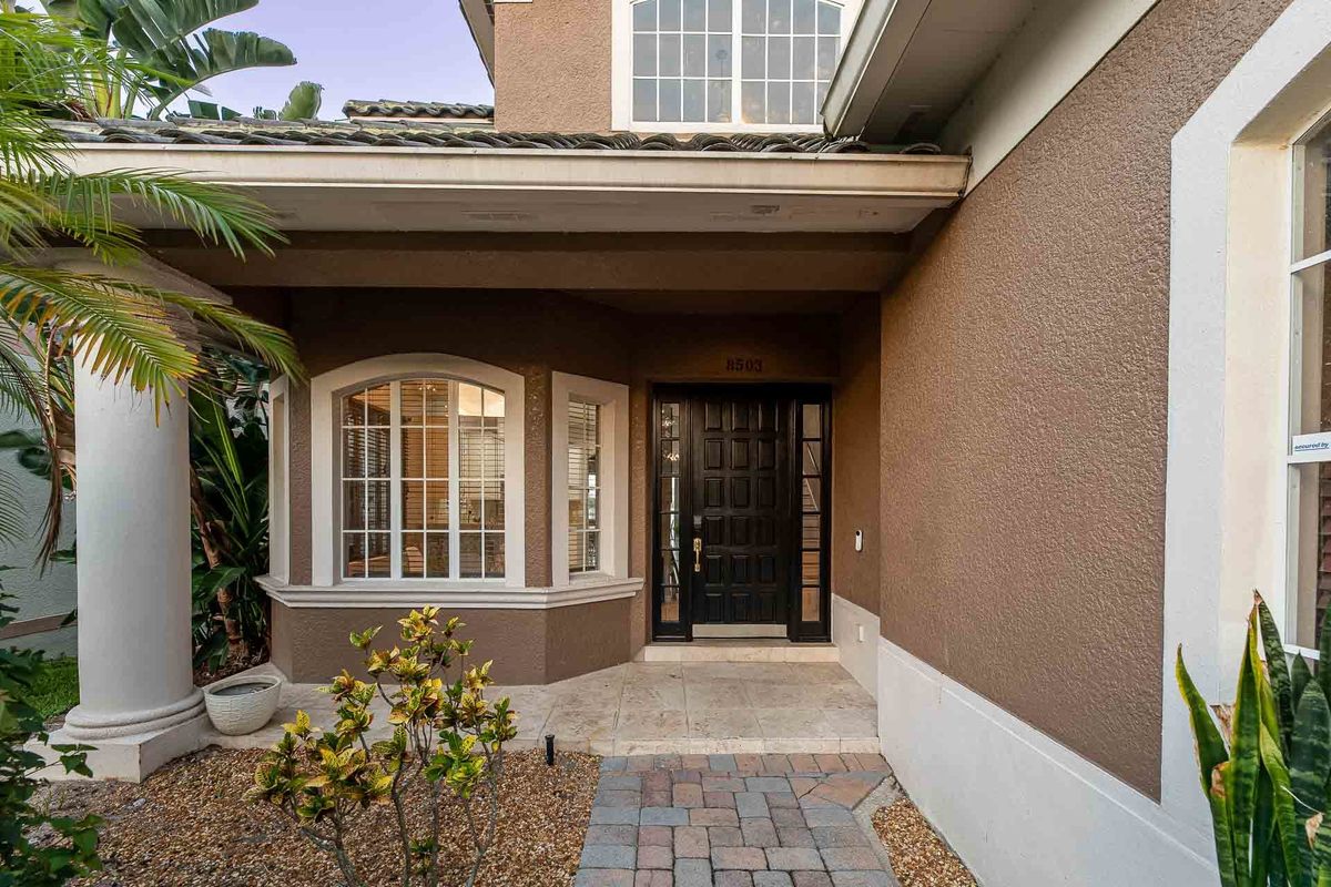 Inviting entrance of a house in Orlando with classic columns and arched windows, highlighted by the photographer.
