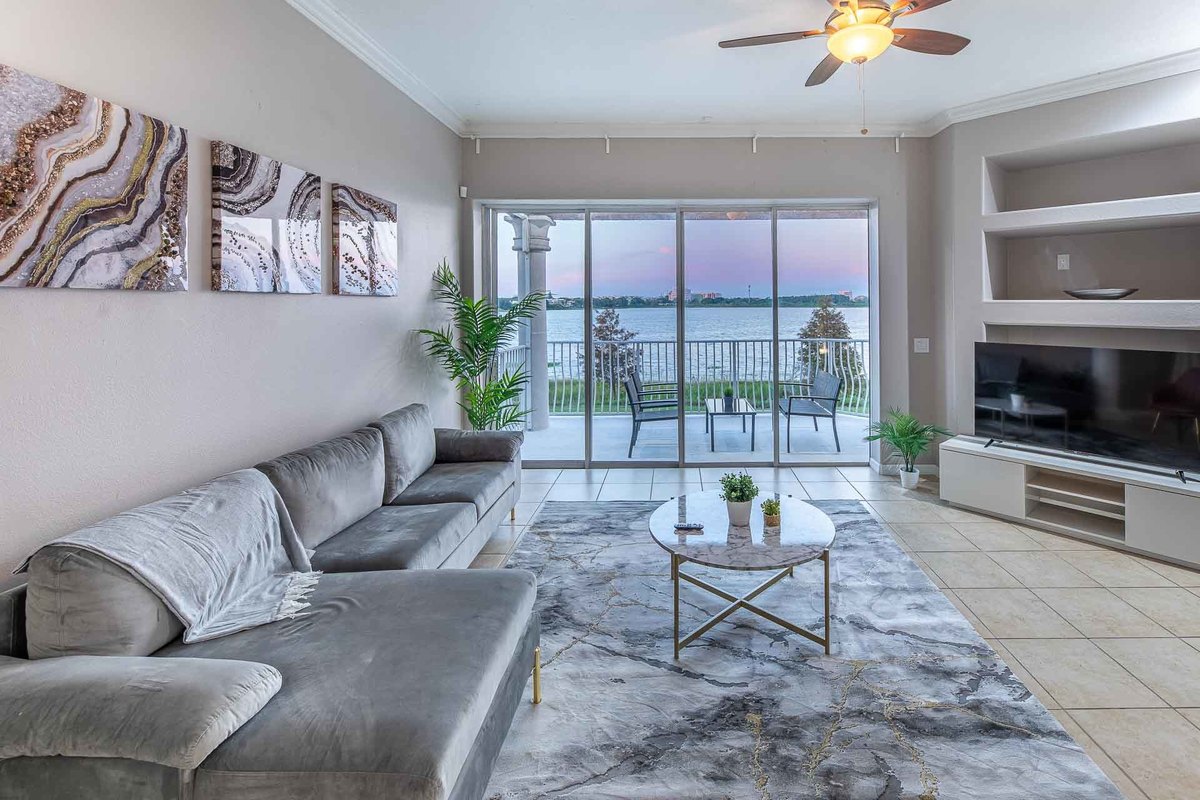 Elegant hallway with a staircase and black accents, lit and photographed in Orlando.