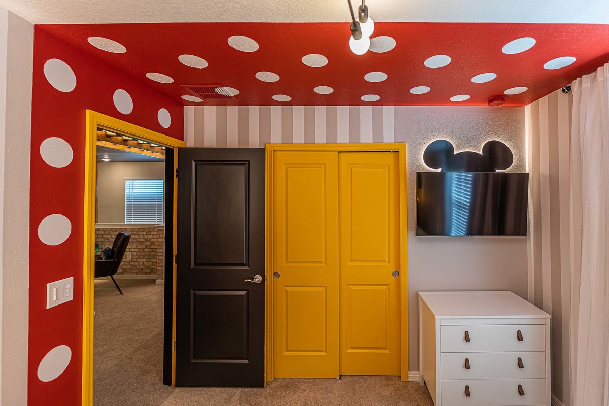 Stylish Disney-themed Hallway: This photo features a hallway creatively adorned with Disney elements, reflecting the architects' skill in thematic interior design in an Orlando vacation home.

