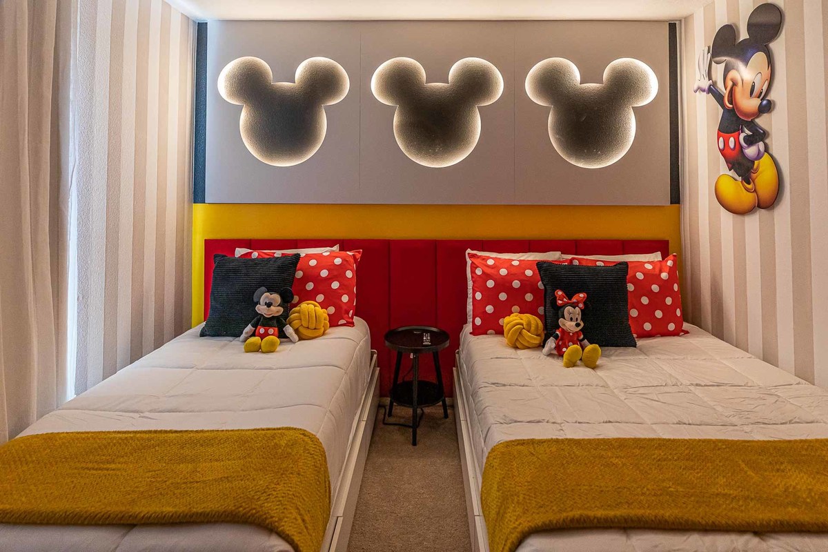 Themed Children's Room: Interior photography captures a charming children's room with a Mickey Mouse theme. Details in red, yellow, and polka dot patterns contribute to a playful and cheerful space, ideal for vacation homes in Orlando.

