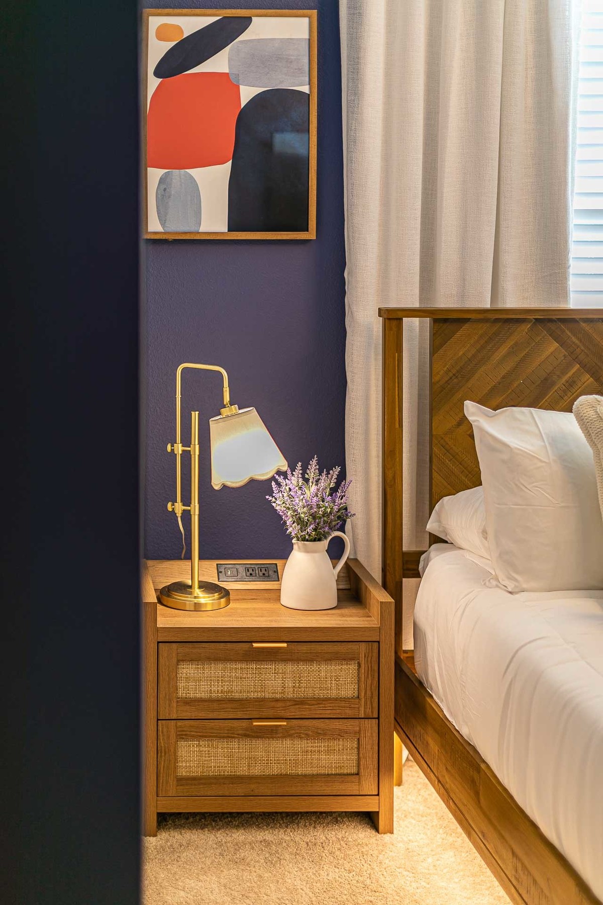 Elegant Bedroom Detail: This interior photo captures a stylish bedroom corner with a modern lamp and artful decor, showcasing the meticulous attention to detail by the architects in this Orlando vacation home.
