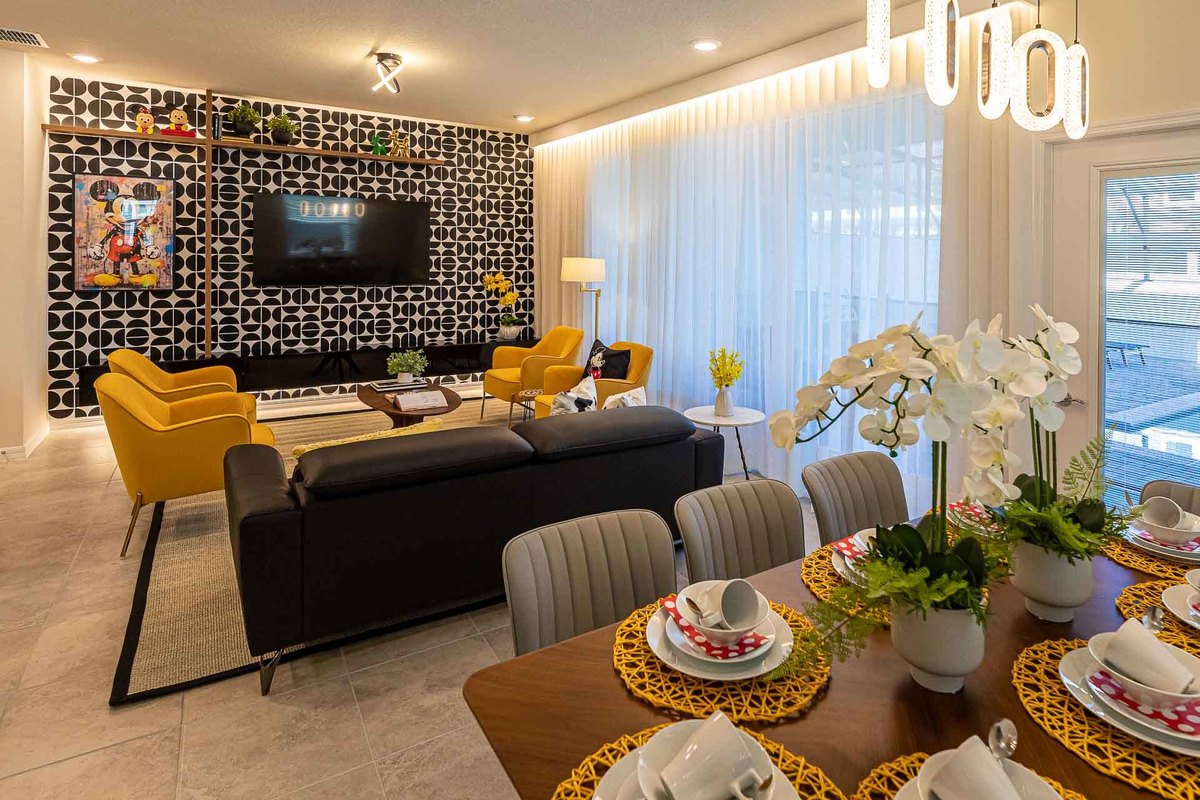 Sophisticated Living and Dining Area: This interior photograph displays a contemporary living and dining space, combining sleek furniture and bold accents, perfect for vacation relaxation in Orlando.
