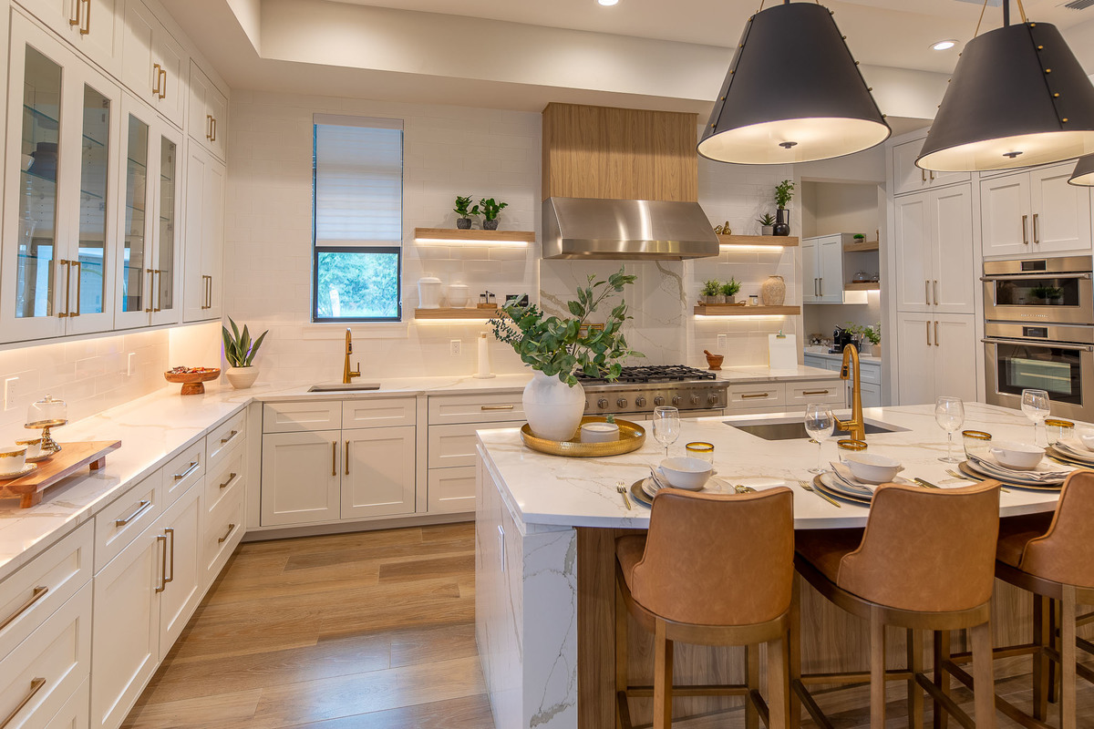 Luxurious kitchen with wooden cabinets, countertop, and beautiful chandeliers in Orlando, FL. Magic Lens Photo Media.