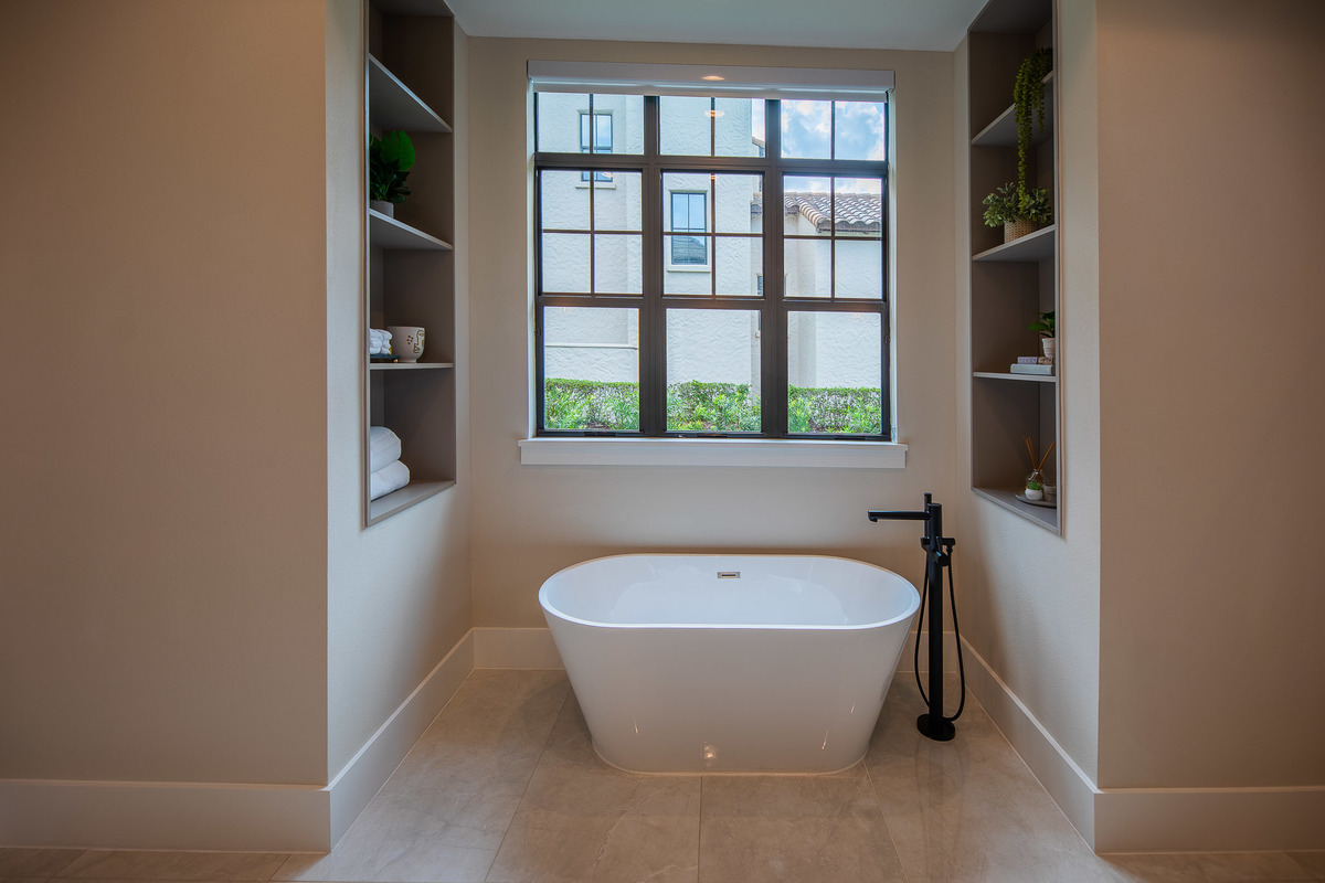 Spacious marble bathroom with a white marble jacuzzi tub in a beautiful property in the Orlando area, FL. Magic Lens Photo Media.