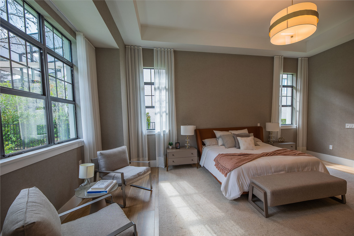 Luxurious bedroom with light beige and pink tones in a beautiful property in Orlando, FL. Magic Lens Photo Media.