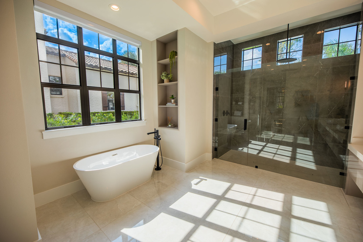 Spacious marble bathroom with a white marble jacuzzi tub in a beautiful property in the Orlando area, FL. Magic Lens Photo Media.