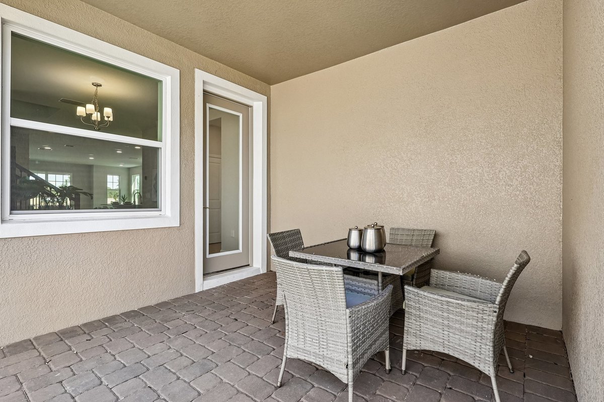 covered-lanai-patio-wicker-dining-set-brick-pavers-stucco-exterior-5348-ctr-lk-rnch-blvd-st-cloud-fl