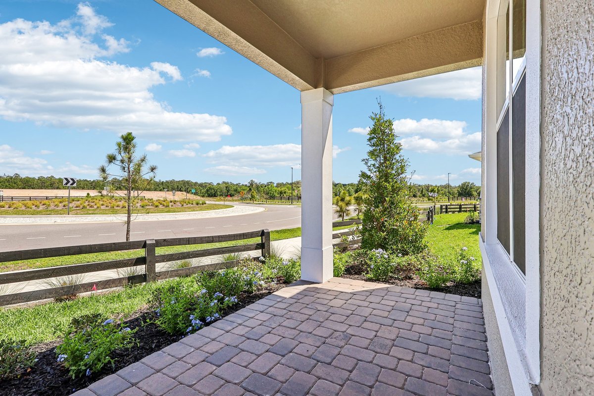covered-patio-brick-pavers-landscaped-garden-community-roundabout-view-new-construction-5348-ctr-lk-rnch-blvd-st-cloud-fl
